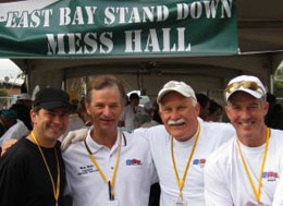 Jim Walberg and three other real-estate professionals stand near the Mess Hall where they served many homeless veterans.