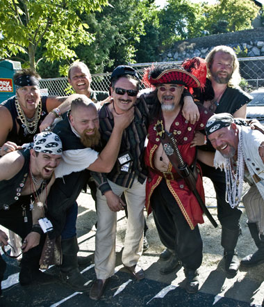 Ilya Moshenskiy, the man usually behind the camera enjoys the company of pirates at Seafair. Ilya is next to the man in red and is wearing sunglasses.